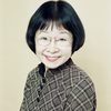 Smiling headshot of Junko Hori with a patterned button-up shirt and glasses